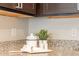 Granite countertop detail, featuring a stylish decor setup at 18972 W Woodlands Ave, Buckeye, AZ 85326