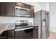 Stainless steel appliances and granite countertops in a modern kitchen at 18972 W Woodlands Ave, Buckeye, AZ 85326