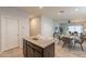 Granite kitchen island with a view of the dining area at 18972 W Woodlands Ave, Buckeye, AZ 85326