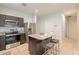 Open concept kitchen with island and breakfast bar seating at 18972 W Woodlands Ave, Buckeye, AZ 85326