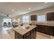 Modern kitchen with granite island and stainless steel appliances at 18972 W Woodlands Ave, Buckeye, AZ 85326