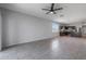 Open living room with tile floors and kitchen view at 18972 W Woodlands Ave, Buckeye, AZ 85326