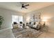 Living room with gray couch and glass coffee table at 18972 W Woodlands Ave, Buckeye, AZ 85326