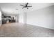 Open living room, tile floor, and kitchen access at 18972 W Woodlands Ave, Buckeye, AZ 85326