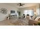 Living room with gray couch and access to backyard at 18972 W Woodlands Ave, Buckeye, AZ 85326