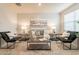 Bright living room with gray sofa and large artwork at 18972 W Woodlands Ave, Buckeye, AZ 85326