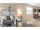 Living room with gray couch and kitchen view at 18972 W Woodlands Ave, Buckeye, AZ 85326