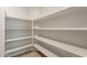 Spacious pantry with ample shelving for storage at 18972 W Woodlands Ave, Buckeye, AZ 85326