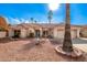 Single-story home with tile roof, desert landscaping, and two-car garage at 19619 N White Rock Dr, Sun City West, AZ 85375