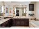 Elegant bathroom with double vanity, soaking tub, and large mirror at 19627 N 101St St, Scottsdale, AZ 85255