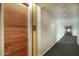 Modern hallway with wood door and carpet flooring at 200 W Portland St # 817, Phoenix, AZ 85003