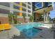 Resort-style pool with lounge chairs and a building view at 200 W Portland St # 817, Phoenix, AZ 85003