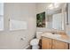 Clean and modern bathroom with wood cabinets and a large mirror at 201 S Greenfield Rd # 353, Mesa, AZ 85206