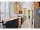 Kitchen with light wood cabinets, stainless steel appliances, and wood-look flooring at 201 S Greenfield Rd # 353, Mesa, AZ 85206