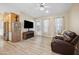 Living room with dark brown recliner, TV, and wood-look flooring at 201 S Greenfield Rd # 353, Mesa, AZ 85206