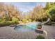 Inviting backyard pool with a slide, surrounded by lush landscaping and a brick patio at 2124 E Virginia St, Mesa, AZ 85213