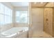 Bathroom with soaking tub and shower with tiled walls at 2124 E Virginia St, Mesa, AZ 85213