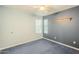 Well-lit bedroom featuring blue carpet and two windows at 2124 E Virginia St, Mesa, AZ 85213