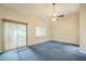 Bright bedroom with blue carpet, ceiling fan and sliding door to patio at 2124 E Virginia St, Mesa, AZ 85213