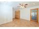 Bedroom with tile floors, ceiling fan, and built-in wooden cabinets at 2124 E Virginia St, Mesa, AZ 85213