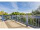 Deck with blue railing overlooking lush trees and blue sky at 2124 E Virginia St, Mesa, AZ 85213