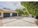 Two-car garage with blue doors and basketball court at 2124 E Virginia St, Mesa, AZ 85213