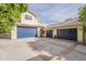 Two-car garage with blue doors and large driveway at 2124 E Virginia St, Mesa, AZ 85213