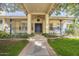 Inviting house entrance with a covered porch, blue door, and landscaped walkway at 2124 E Virginia St, Mesa, AZ 85213