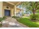 House exterior featuring a front porch, blue door, and landscaping at 2124 E Virginia St, Mesa, AZ 85213