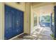 Front entrance with blue double doors and a porch swing at 2124 E Virginia St, Mesa, AZ 85213