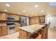 Kitchen with wood cabinets, granite island, and stainless steel appliances at 2124 E Virginia St, Mesa, AZ 85213