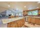 Kitchen with granite island, wood cabinets, and stainless steel appliances at 2124 E Virginia St, Mesa, AZ 85213