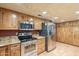 Kitchen features stainless steel appliances and wood cabinets at 2124 E Virginia St, Mesa, AZ 85213