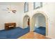 Spacious living room with decorative arches and blue carpeting at 2124 E Virginia St, Mesa, AZ 85213