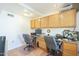 Home office with wood cabinets and two workstations at 2124 E Virginia St, Mesa, AZ 85213