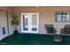 Covered patio with artificial turf and two wicker chairs at 2270 S Apache Dr, Apache Junction, AZ 85120