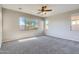 Spacious bedroom with carpeted floor and ceiling fan at 29302 N 126Th Ln, Peoria, AZ 85383