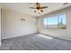 Bright bedroom with carpeted floor and large window at 29302 N 126Th Ln, Peoria, AZ 85383