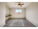 Bedroom with built-in desk and ceiling fan at 29302 N 126Th Ln, Peoria, AZ 85383