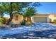 Single-story home with a two-car garage and desert landscaping at 29302 N 126Th Ln, Peoria, AZ 85383