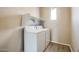 Laundry room with washer, dryer, and shelving at 29302 N 126Th Ln, Peoria, AZ 85383