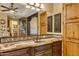 Vanity with granite countertop and dark wood cabinets, offering ample storage at 3257 N Piedra Cir, Mesa, AZ 85207