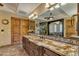 Bathroom features a large vanity with granite countertop and wood cabinets at 3257 N Piedra Cir, Mesa, AZ 85207