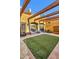 Charming courtyard with pergola and lush green grass at 3257 N Piedra Cir, Mesa, AZ 85207