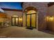 Inviting entryway with a fireplace and wrought iron doors at 3257 N Piedra Cir, Mesa, AZ 85207