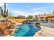 Inviting pool with a waterfall and expansive backyard view at 3257 N Piedra Cir, Mesa, AZ 85207