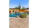 Stunning pool with a rock waterfall and desert landscape at 3257 N Piedra Cir, Mesa, AZ 85207