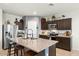 Modern kitchen with granite island, stainless steel appliances, and dark brown cabinets at 3422 N Cinnabar Pl, Casa Grande, AZ 85122