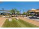 Community area with cornhole and shaded seating at 3751 E Archer Dr, San Tan Valley, AZ 85140