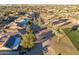 Aerial view of homes with solar panels, situated by a golf course at 3755 N 161St Ave, Goodyear, AZ 85395